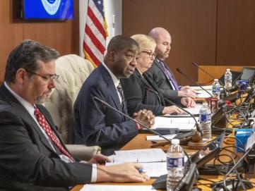 Image shows four EAC Commissioners at the dais. 