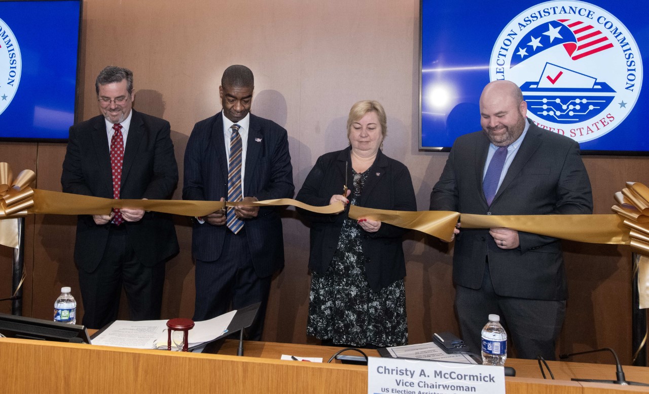 EAC Commissioners pose for photo during a ribbon cutting ceremony to commemorate the opening of the EAC's new Hearing Room. This first Public Hearing took place on November 15th, 2022. Pictured from left to right: Commissioner Palmer, Chairman Hicks; Vice Chair McCormick; Commissioner Hovland.