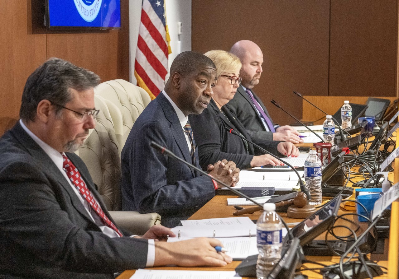 Photo showing side profile of EAC Commissioners as they address the attendees during a Public Hearing on Nov. 15th, 2022. Pictured from left to right:  Commissioner Palmer, Chairman Hicks; Vice Chair McCormick; Commissioner Hovland.