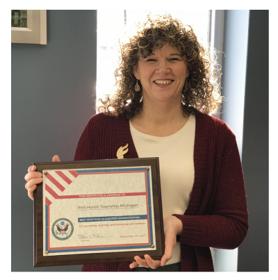 Benita Davis Clerk from Port Huron Township is holding an EAC clearinghouse Award for Best Practices in election administration for recruiting, training and retaining poll workers 