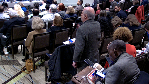 Jim Dickson standing and asking question of the workshop participants