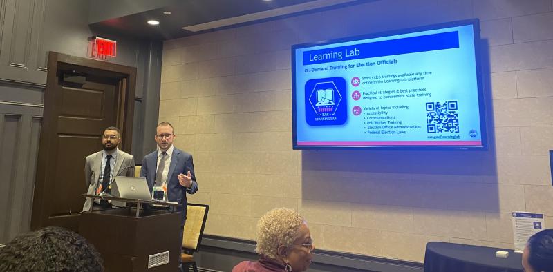EAC staff members are shown to the left conducting training. A tv screen shows an image about the Learning Lab to the right.